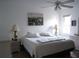 Spacious main bedroom with king-size bed and ceiling fan at 407 Lake Point Ct # 4E, Sun City Center, FL 33573