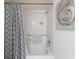 Bathroom with shower/tub, gray geometric shower curtain at 4316 Tahitian Gardens Cir # H, Holiday, FL 34691