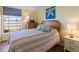 Bedroom with a double bed, dresser, and water views at 4316 Tahitian Gardens Cir # H, Holiday, FL 34691