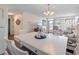 White dining table with seating for six in bright dining room at 4316 Tahitian Gardens Cir # H, Holiday, FL 34691