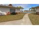 Back exterior view of home showcasing a walkway and pond views at 4316 Tahitian Gardens Cir # H, Holiday, FL 34691