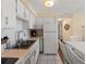 White kitchen with stainless steel sink and appliances at 4316 Tahitian Gardens Cir # H, Holiday, FL 34691