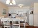 Bright kitchen features white cabinets, and a table with four chairs at 4316 Tahitian Gardens Cir # H, Holiday, FL 34691