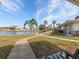 Peaceful waterfront view with walking paths and lush landscaping at 4316 Tahitian Gardens Cir # H, Holiday, FL 34691