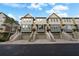 Three-story townhouses with attached garages and stairs, street view at 4334 Spinnaker Cove Ln, Tampa, FL 33615