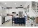 Modern kitchen with white cabinets, stainless steel appliances and a blue island at 4334 Spinnaker Cove Ln, Tampa, FL 33615