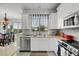 Modern kitchen with white cabinets, stainless steel appliances and a tile backsplash at 4334 Spinnaker Cove Ln, Tampa, FL 33615