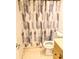 Small bathroom featuring a toilet, vanity and patterned shower curtain at 4405 W Fair Oaks Ave # 10, Tampa, FL 33611