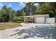 Updated home with a large front yard, driveway, and white fence at 4822 W Bay Court Ave, Tampa, FL 33611