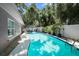 Inviting kidney-shaped pool with surrounding landscaping at 4822 W Bay Court Ave, Tampa, FL 33611