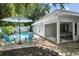 Inviting pool area featuring blue chairs and a striped umbrella at 4822 W Bay Court Ave, Tampa, FL 33611