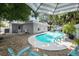 Relaxing pool area with patio chairs and umbrella at 4822 W Bay Court Ave, Tampa, FL 33611