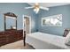 Serene bedroom featuring a twin bed, built-in dresser, and a calming light blue color scheme at 4996 Felecity Way, Palm Harbor, FL 34685