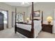 Spacious bedroom with a large four-poster bed and access to a private balcony at 4996 Felecity Way, Palm Harbor, FL 34685