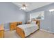 Charming bedroom with twin bed, light wood furniture, and a ceiling fan at 4996 Felecity Way, Palm Harbor, FL 34685