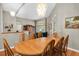 Dining room with hardwood floors, a large table, and views of the living room at 4996 Felecity Way, Palm Harbor, FL 34685