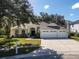 Three-car garage home with landscaped yard at 4996 Felecity Way, Palm Harbor, FL 34685