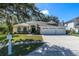 Single-story house with three-car garage and landscaped lawn at 4996 Felecity Way, Palm Harbor, FL 34685