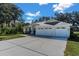 House with three-car garage and front yard at 4996 Felecity Way, Palm Harbor, FL 34685