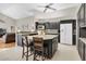 Kitchen with dark wood cabinets, granite island, and stainless steel appliances at 4996 Felecity Way, Palm Harbor, FL 34685