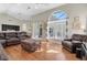 Bright living room with hardwood floors, sectional sofa and large windows at 4996 Felecity Way, Palm Harbor, FL 34685