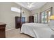 Main bedroom with a large window, wood furniture, and carpeted floors at 4996 Felecity Way, Palm Harbor, FL 34685