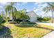 House with palm trees, lush landscaping, and a two-car garage at 5004 Brickell Park Cv, Bradenton, FL 34211