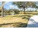 Peaceful pond with a walking path, surrounded by lush greenery and mature trees at 5004 Brickell Park Cv, Bradenton, FL 34211