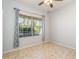 Spacious bedroom with large window and tile flooring at 5004 Brickell Park Cv, Bradenton, FL 34211