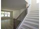 Modern staircase with dark wood railing and white risers at 507 N Bradford Ave, Tampa, FL 33609