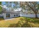 Backyard view showing a home with grass and fence at 5605 Tanagergrove Way, Lithia, FL 33547