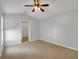 Spacious bedroom with ceiling fan and carpeting at 5605 Tanagergrove Way, Lithia, FL 33547