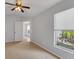 Bedroom with ceiling fan, carpeting, and backyard view at 5605 Tanagergrove Way, Lithia, FL 33547