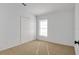 Well-lit bedroom with double door closet and carpeting at 5605 Tanagergrove Way, Lithia, FL 33547