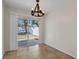 Bright dining area with chandelier and sliding glass doors to backyard at 5605 Tanagergrove Way, Lithia, FL 33547