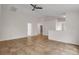 Bright living room featuring tile flooring and a ceiling fan at 5605 Tanagergrove Way, Lithia, FL 33547