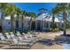 Relaxing lounge chairs are set up by the community pool at 5605 Tanagergrove Way, Lithia, FL 33547