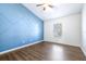 Bedroom with blue accent wall and wood-look floors at 6003 Tealside Ct, Lithia, FL 33547