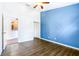 Bedroom with blue accent wall and view of the kitchen at 6003 Tealside Ct, Lithia, FL 33547