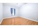 Simple bedroom with wood-look floors and striped curtains at 6003 Tealside Ct, Lithia, FL 33547