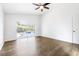 Bright bedroom with wood-look floors and sliding glass doors leading to a pool at 6003 Tealside Ct, Lithia, FL 33547