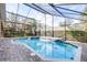 Inviting screened pool and spa with brick pavers at 6003 Tealside Ct, Lithia, FL 33547