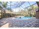 Screened pool and spa with brick pavers and a covered patio at 6003 Tealside Ct, Lithia, FL 33547