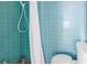 Small bathroom with teal tile and shower at 6170 7Th N Ave, St Petersburg, FL 33710