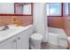 Bathroom with pink tile, tub, and white vanity at 6170 7Th N Ave, St Petersburg, FL 33710