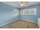 Bedroom with light blue walls and large window at 6170 7Th N Ave, St Petersburg, FL 33710