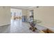 Dining room with tiled floors, glass-top table, and access to a sunroom at 6170 7Th N Ave, St Petersburg, FL 33710