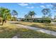 Green Ranch home with palm trees and a wide yard at 6170 7Th N Ave, St Petersburg, FL 33710