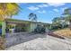 Mid-century home with carport and tropical landscaping at 6170 7Th N Ave, St Petersburg, FL 33710