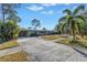 Ranch style home with a long driveway and palm trees at 6170 7Th N Ave, St Petersburg, FL 33710